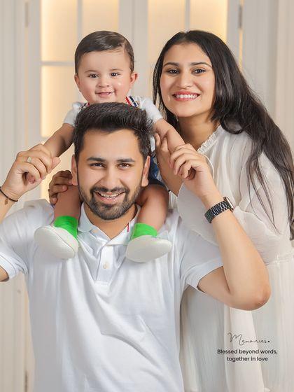 A beautiful family of three, perfectly posed and smiling for the camera. This is a classic family portrait that will be cherished for years.