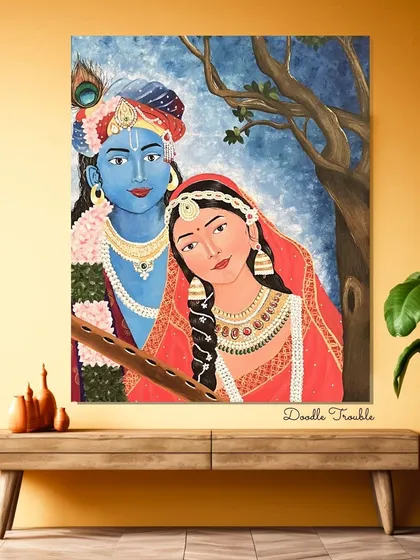 The Radha Krishna painting displayed on a wooden console against a warm-toned wall. This setup highlights the painting's traditional feel and shows how it can create a focal point in a cozy space.