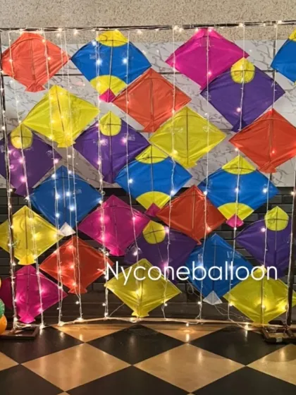 I built this colorful kite wall to serve as a photo booth backdrop for a Lohri party. The fairy lights woven through the kites add a beautiful sparkle, making it a popular spot for guests to take pictures.
