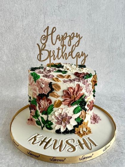 A beautiful birthday cake with a textured, palette-knife floral design. The mix of colours and textures gives it an artistic, impressionistic feel.