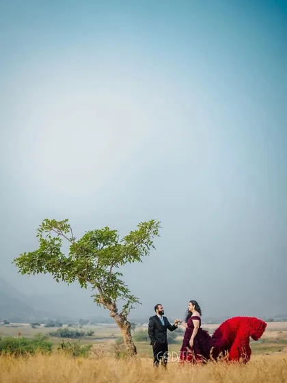 A wide shot that captures the feeling of being in your own world together. The pop of color from the gown against the minimalist landscape is simply stunning.