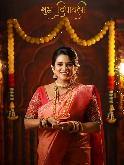A joyful portrait of a woman in a traditional saree holding a diya, with "Shubh Deepavali" written in Marathi, perfectly capturing the Diwali spirit.