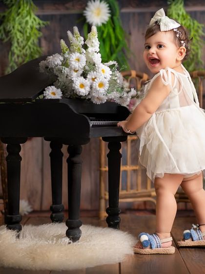 Exploring the set and playing with props like this miniature piano makes the photoshoot a fun experience for your little one, resulting in natural, happy photos.