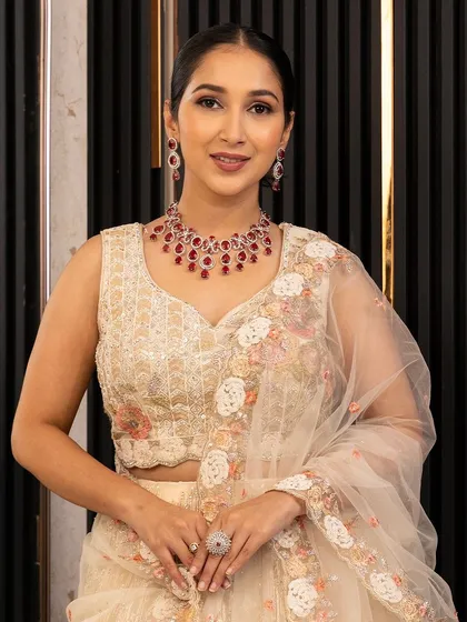 A close-up of the beautifully embroidered blouse paired with our ivory floral lehenga. We also offer stunning jewellery sets for rent to complete your bridal or festive look.