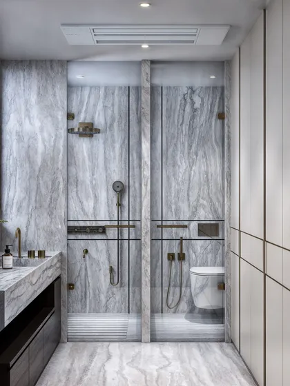 A full view of the grey marble bathroom, showing the well-organized layout with separate glass enclosures for the shower and toilet.