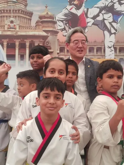 A Korean Grandmaster with our young students. These interactions are invaluable for inspiring our kids.