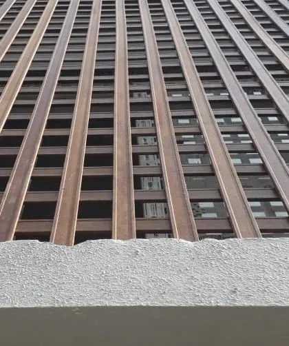 A detailed look at a facade created with our eco-friendly Tipwood. This grid-like design offers partial screening and creates beautiful light and shadow patterns, showcasing the material's versatility.