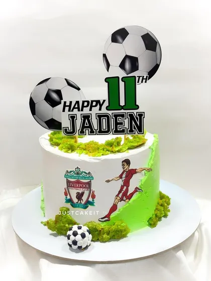 A simple yet effective football theme cake for a Liverpool fan. The design features the team's logo and a player in action, making it a great choice for any sports lover.