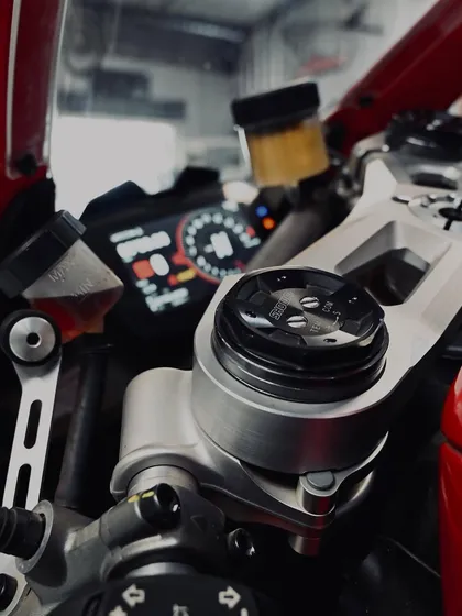 A close-up of the controls and front brake reservoir on the Ducati Panigale V4.