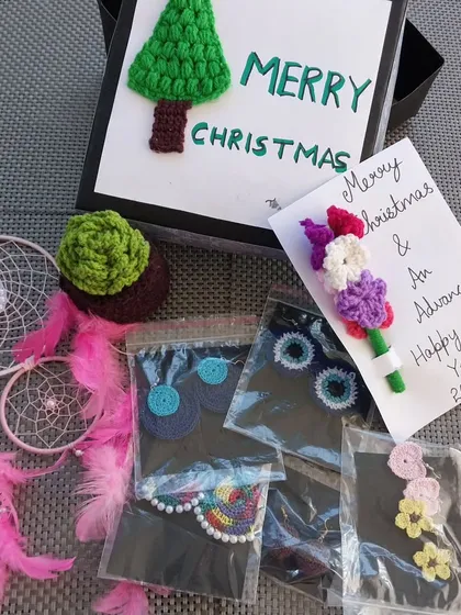 A secret Santa hamper I put together, filled with a variety of my crochet creations like earrings, a dreamcatcher, and a mini bouquet.