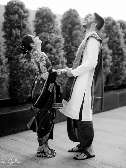 A burst of shared laughter between Karan and Shruti. Black and white photography is perfect for freezing these energetic, joyful moments in time.