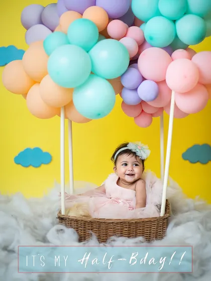 Announcing a very special milestone! This half-birthday hot air balloon shoot is a burst of pastel color and pure joy, perfect for celebrating your baby's first six months.