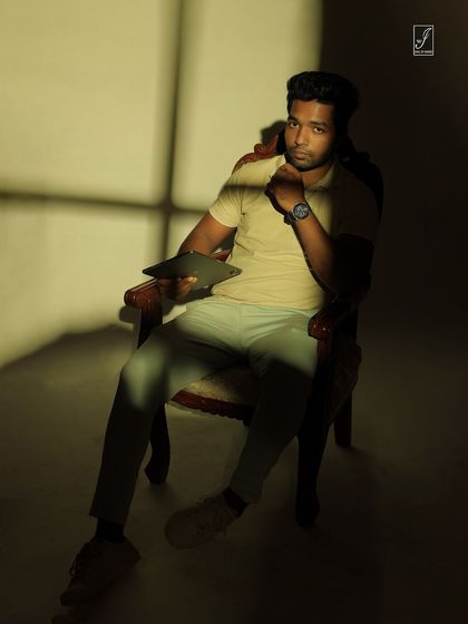 A direct look at the camera through the shadows, creating a powerful and engaging conceptual portrait.