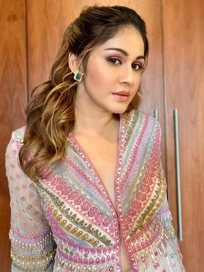 A colorful and glamorous look for a store launch event. The makeup features a pop of pink on the eyes to match the stunning outfit.