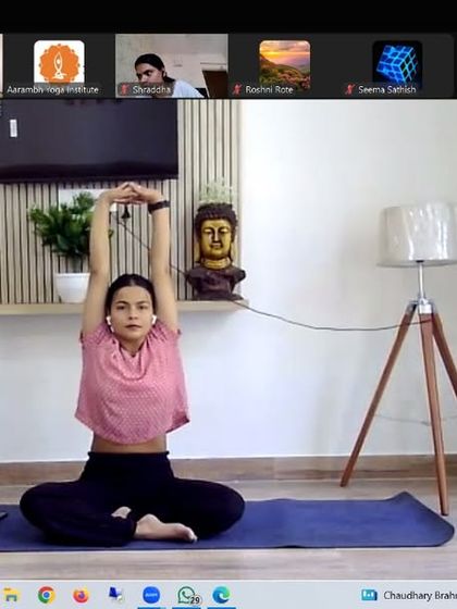An instructor demonstrates a seated arm stretch during our Stress Management Yoga Workshop. Simple movements like these can be done at your desk to release tension in the shoulders and upper back.