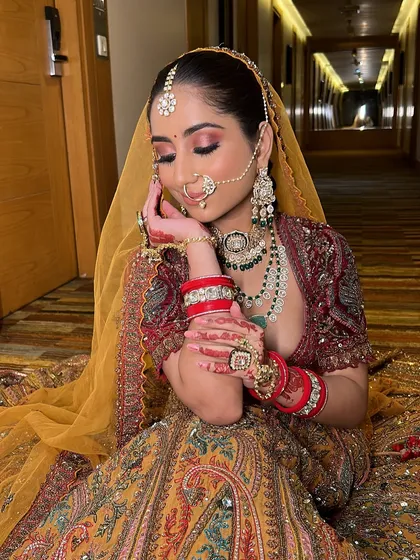 Bringing bridal dreams to life, one brushstroke at a time. This bride looks absolutely stunning in her unique, multi-colored lehenga with a yellow dupatta.