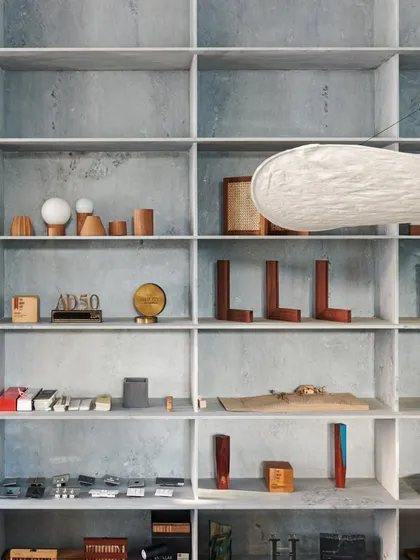 Our material library and model display, housed in a floor-to-ceiling grid of marble shelves. This library is a working tool and a source of inspiration, showcasing our commitment to detail, finesse, and simplicity.