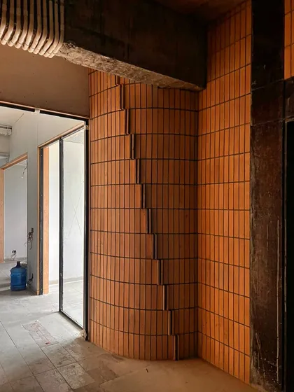 A detail of the "pixelated" brickwork, with sections of brick stepping in and out to create a dynamic, three-dimensional surface.