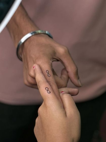 Another shot of the matching infinity tattoos, showing the clean and simple final result.