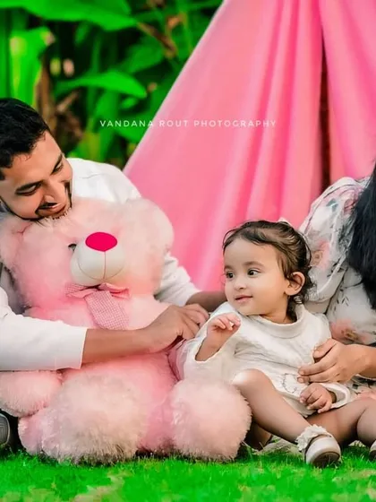 A sweet family portrait with a pink teddy bear and tent prop. I can incorporate fun props into your family or toddler shoot to create a playful and memorable theme.
