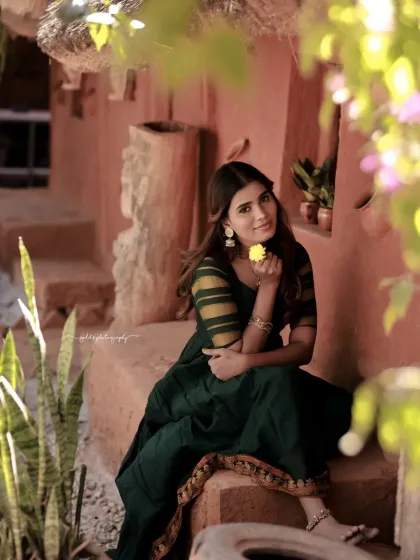 Portraits of a model in a green dress, captured in a traditional house setting. The warm, earthy tones of the location complement the outfit and create a peaceful, grounded mood.
