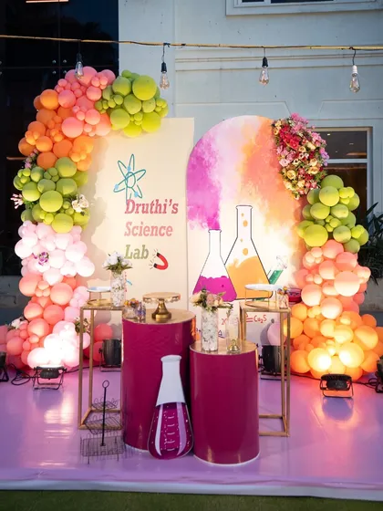 For a truly unique celebration, I designed this "Science Lab" themed birthday party. The decor features a vibrant balloon arch, custom backdrops with scientific flask illustrations, and themed props to create an immersive experience.