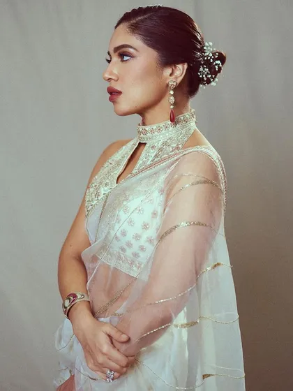 This look for Bhumi Pednekar is pure elegance. I chose this sheer white saree with a high-neck embroidered blouse, perfect for an awards show where she wanted a graceful and sophisticated Indian look.