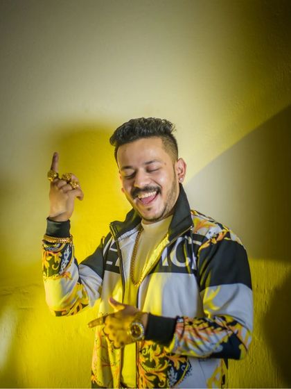 Capturing a moment of genuine laughter and energy. The bright yellow light adds a vibrant, playful feel to this portrait, showcasing a different, more candid side of men's fashion photography.