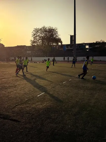 Players train on the pitch during sunrise, their long shadows stretching across the turf. This shot symbolizes the hard work our players put in while others are still asleep.