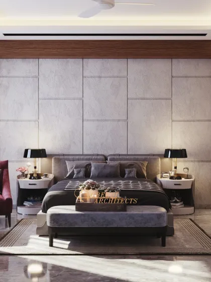 A bedroom that balances grandeur with coziness. The large, textured headboard wall is the main feature, complemented by soft lighting and a plush grey color scheme.