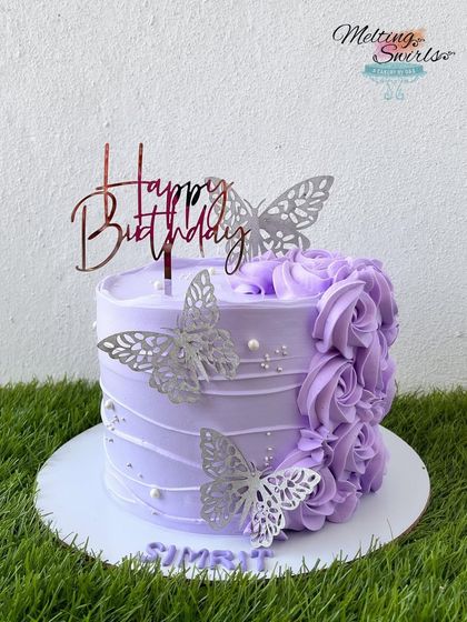 A lovely purple cake decorated with piped rosettes and silver butterflies. This design is simple, elegant, and perfect for any celebration.