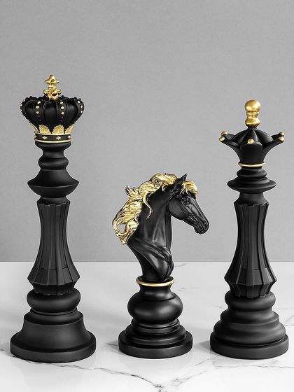 This sleek, all-black chess piece set is accented with touches of gold. The matte finish and classic design give it a modern, sophisticated feel, perfect for a study or game room.