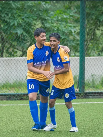 Two of our U15 players celebrating a moment together on the pitch during a league game.