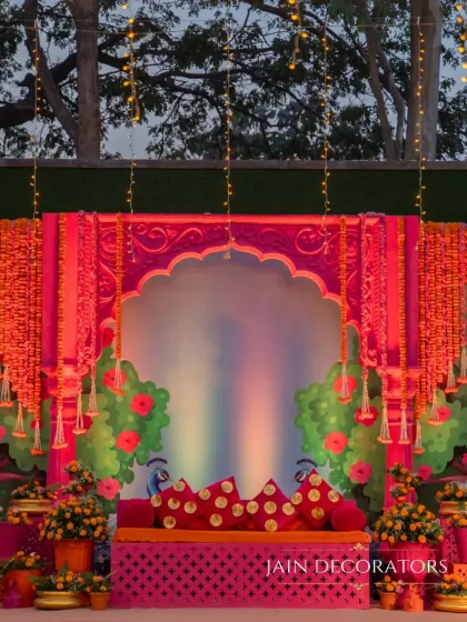 For a Haldi or Mehndi, I love to play with vibrant traditions. This stage is a burst of joyful color, combining fuchsia, marigold, and intricate Rajasthani-inspired architecture to create a festive and photo-perfect setting.