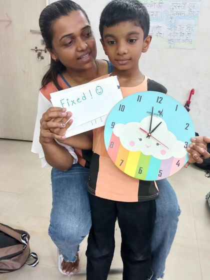A mother and son proudly display the clock they repaired together. Our workshops are a great opportunity for families to learn and create together.