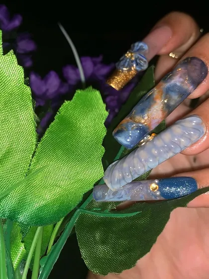 A detailed close-up of the marbling and textured effects on the nail extensions.