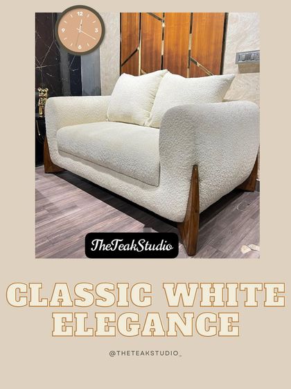 Classic white elegance. This two-seater sofa in a textured white bouclé fabric features distinctive curved wooden legs, offering a sophisticated and timeless look for any living space.