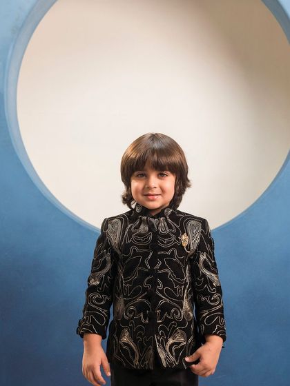 A front on view of the black and gold paisley embroidered bandhgala. This is a classic Jodhpuri style jacket that I've updated with a modern print.