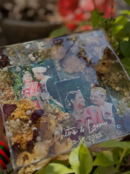A square resin frame preserving wedding flowers and multiple photos from the special day. This is a great way to capture different moments in one keepsake.