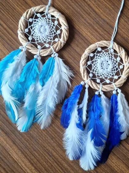 Serenity in motion. This pair of blue and white feathered dreamcatchers was crafted to keep your vibes in check while you chase your dreams on the road.