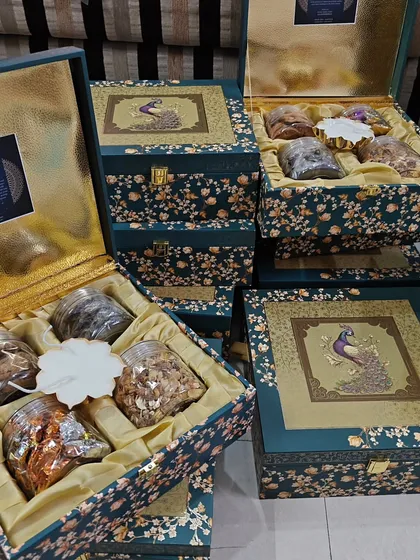 I believe wedding gifts should be as grand as the occasion itself. This collection of royal peacock-themed wedding trunk boxes is designed for luxury gifting. The intricate floral design and satin-lined interior can be filled with dry fruits, chocolates, or other custom items for a truly premium wedding favor.