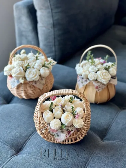 Our flower bouquet basket is perfect for gifting or decorating your space. This wicker basket is filled with beautiful white wax flowers.