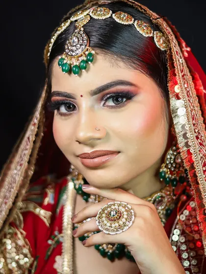 Another portrait of the red and green bridal look, showing the makeup from a different angle.