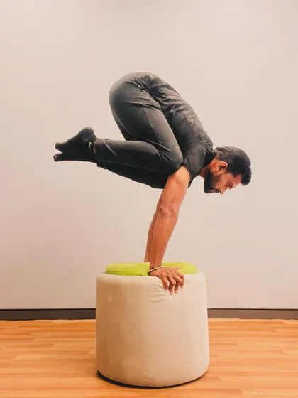 The focus required for an elevated arm balance is immense. It's a meditation in motion, demanding full presence in the moment.