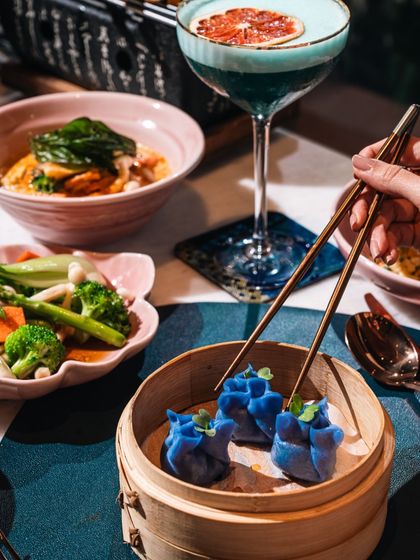 A perfect pairing of food and drink at Kokoon. Our vibrant blue pea flower dim sum is complemented by a striking blue cocktail, creating a visually stunning and delicious combination.