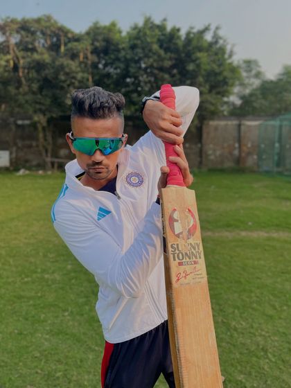 A classic cricketer's pose with the bat.