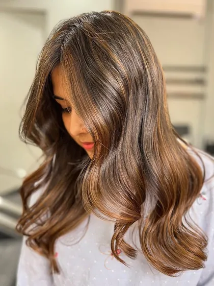 A beautiful caramel blonde balayage that proves style is timeless. The color is expertly blended for a seamless and natural effect.