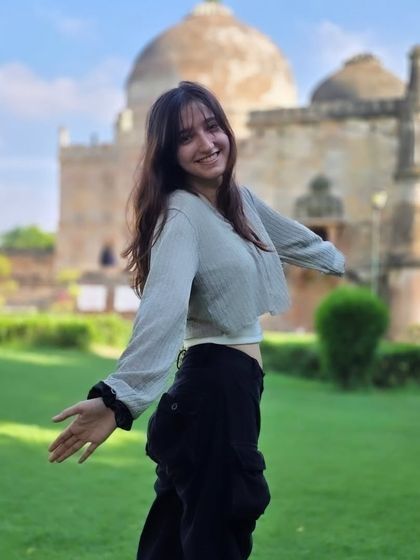 A joyful, open-armed pose that radiates happiness and freedom. This candid moment perfectly captures the fun and carefree spirit of the shoot.