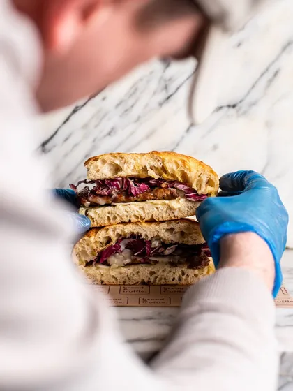 Another angle of the food styling process, showing the careful placement of ingredients to build the perfect sandwich stack for the camera.