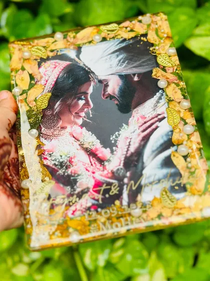The way the light hits the golden leaves and preserved flowers makes this piece truly shine. It’s a beautiful tribute to a couple's wedding day.